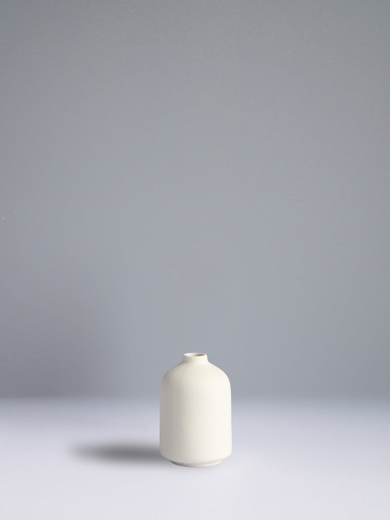 White ceramic vase on a gray background